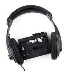 Old headphones and cassette player isolated on white