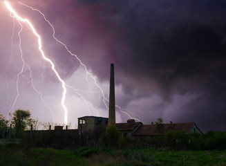 Thunder, lightnings and storm over abandoned factory in summer