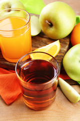 Assortment of healthy fresh juices and fruits on wooden table background