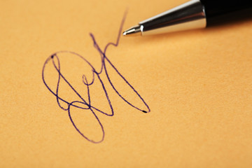 Fototapeta premium Pen and signature on paper background