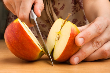 hands cutting an apple - Powered by Adobe