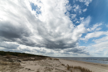 Fototapeta na wymiar White clouds over beach