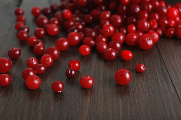 Red cranberries on wooden table, closeup