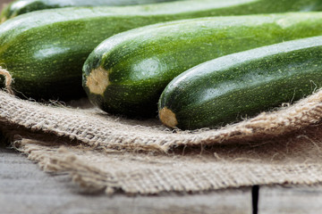 Green zucchini on wooden table