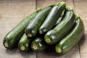 Green zucchini on wooden table