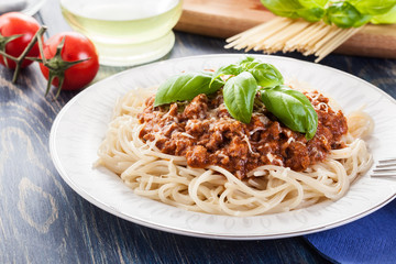 Spaghetti bolognese with cheese and basil