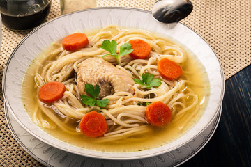 Chicken broth with noodles and carrot