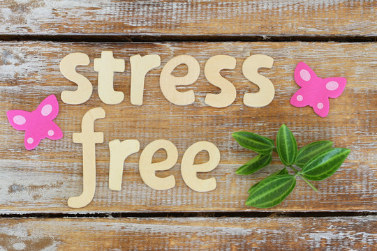 Stress free written with wooden letters on rustic surface

