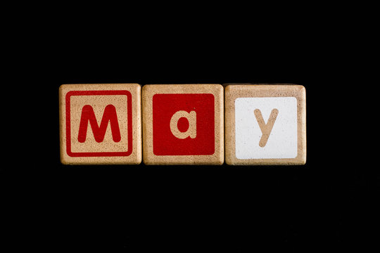may on wood Cubic on black background
