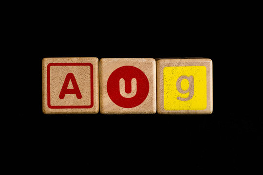 August on wood Cubic on black background