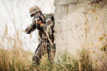 military soldier shooting an assault rifle