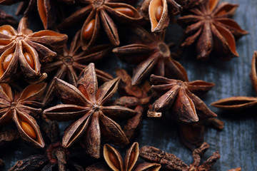 Star anise fruits and seeds on the wooden background