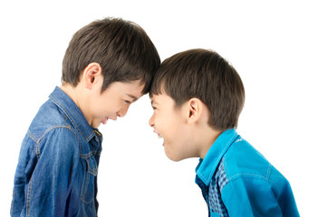 Little sibling boy fighting on white background
