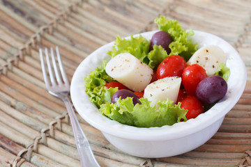 Fresh salad of heart of palm (palmito), cherry tomatos, olives