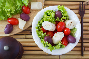 Fresh salad of heart of palm (palmito), cherry tomatos and olive