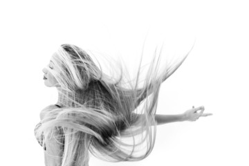 Cheerful girl dancing and throwing her hair black and white
