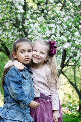 Little girls playing in spring park tree outdoor