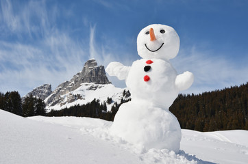 Obraz premium Funny snowman against Swiss Alps
