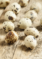 Quail eggs on a wooden table, selective focus