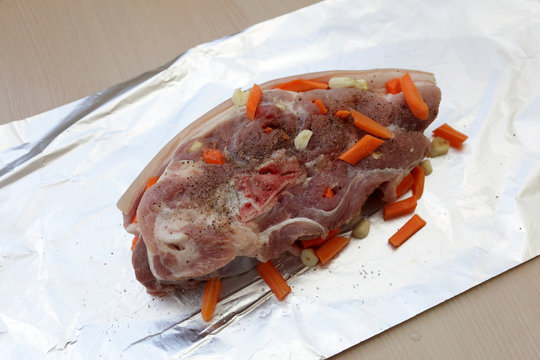 Raw pork shoulder with carrots