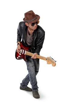 Young rocker playing guitar casually, isolated on white 