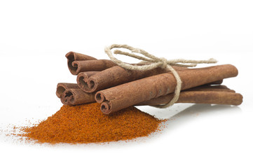 cinnamon sticks with powder on the white background