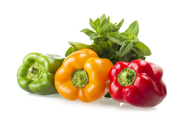 colored peppers close up over white background