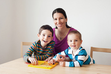 Happy family playing a board game © o_likas
