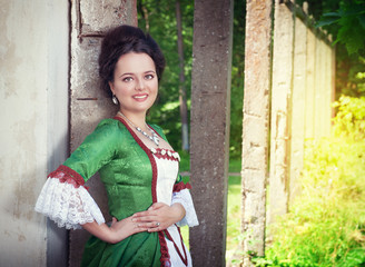 Beautiful young woman in green medieval dress