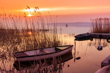 Sunset on the lake Balaton with a boat - obrazy, fototapety, plakaty