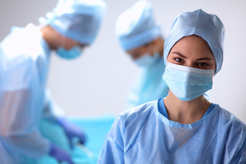 Team surgeon at work in operating room.