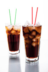 two glasses of cola on white background. soft drinks