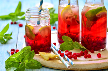 Cold redcurrant tea with lemon and mint. © lilechka75