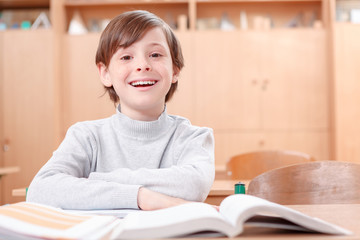 Smiling boy sitting at desk