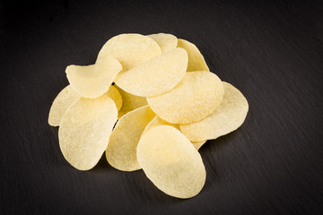 Potato chips on a black background