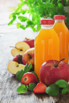 fruit juice, ripe apples and strawberries
