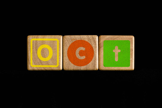 October on wood Cubic on black background