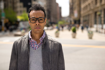 Young African Asian man in New York City serious face portrait