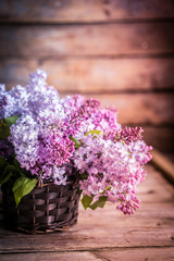 Bouquet of lilacs on wooden background