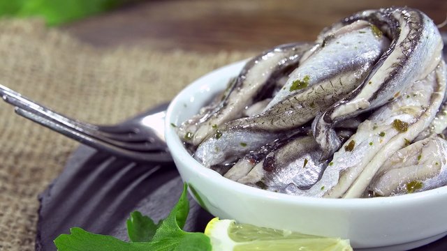 Portion of pickled Anchovies (seamless loopable 4K UHD footage)