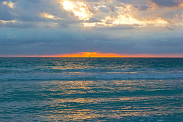 Fototapeta na wymiar Sunrise on a cloudy day in Miami Beach, Florida.