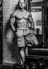 Naklejka na ściany i meble Black and white photo of awesome bodybuilder