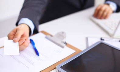 Man's hand giving business card 