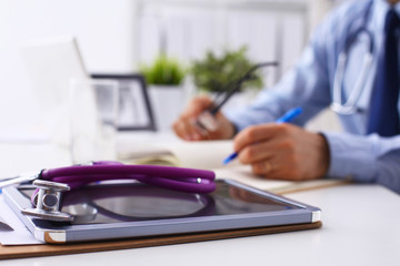 Male doctor sitting at his desk