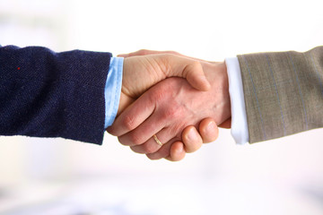 Closeup of a business handshake, on white background