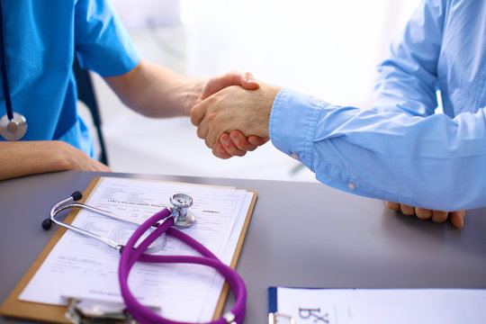 Handshake between doctor and a patient in the office