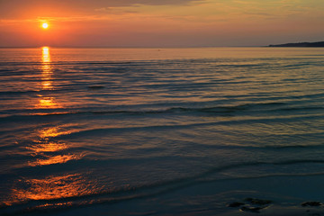 Fototapeta na wymiar Bright orange sunset at the sea