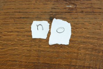 Torn letters against wood background