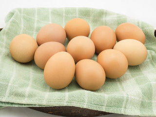 Eggs with cloth in basket on white background.