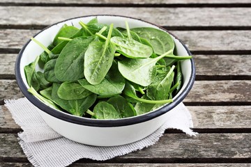 Fresh herbs on a rustic wooden table.